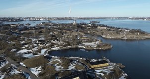 Aerial footage of Suomenlinna Sveaborg fortress and lagoon on Baltic Sea with cannons, submarine and boats in bright spring day near Helsinki. Finland Suomi, Scandinavia
