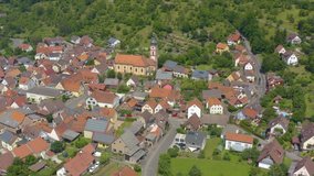 Aerial view of the village Reicholzheim in Germany. Pan to the left beside the church.
