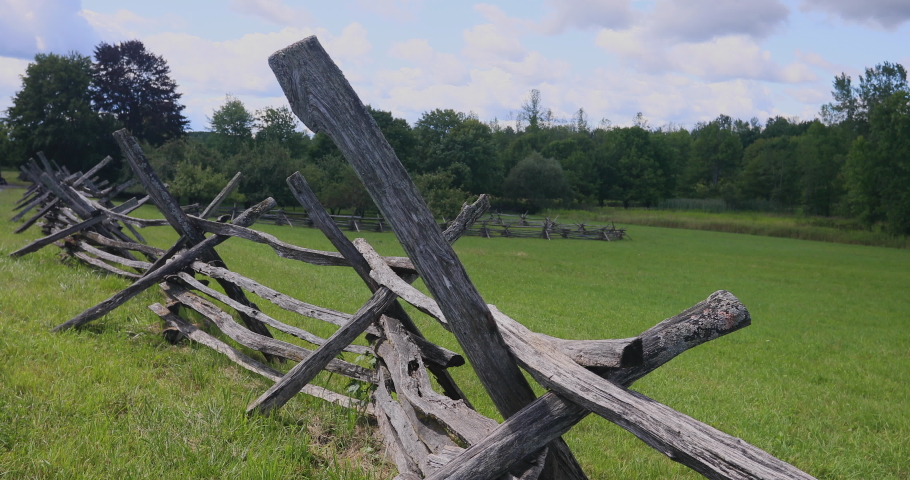 Split wood rail fence around apple orchard Palmyra New York . Old historic homestead of leader of LDS Mormon religion. Wooden fence around apple orchard upper New York rural landscape.