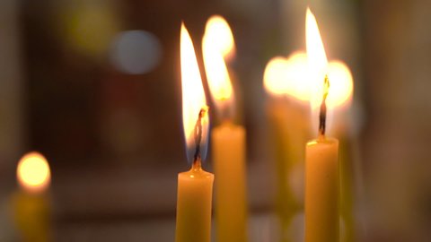 Madaba / Jordan - 01 11 2019: Madaba, Jordan, January 2019 - A Burning Yellow Thin Candles With Clearly Visible Candle Wicks Inside of Madaba St George's Greek Orthodox Church