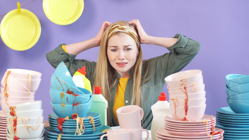 Displeased emotional depressed frustrated housewife washing dishes. Housewife expresses negative emotion | Shutterstock HD Video #1035665930