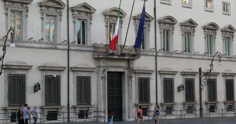 Rome, Italy - August 15, 2019: Palazzo Chigi, institutional seat of the Italian government. The main entrance with the building facade and flags.