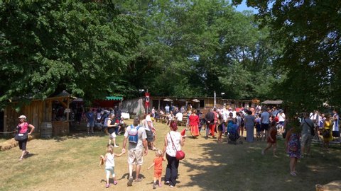 LA ROCHEFOUCAULD, FRANCE - circa JULY 2019. MEDIEVAL FESTIVAL. French tourists arriving in middle age old village.