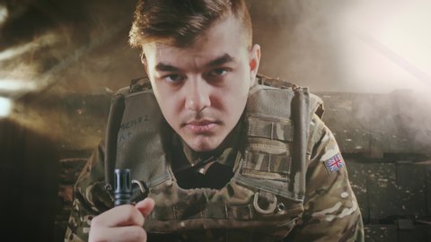 Portrait of an English military sad man. Fashion Model in camouflage uniforms. Young adult 20s. National patriot in london. Officer for safety. Operation of security in camp. Caucasian ethnicity 4k.