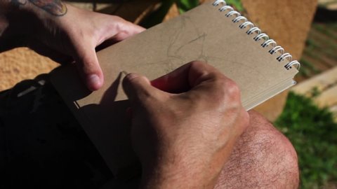 Valle Guerra , Tenerife / Spain - 12 31 2018: Man's hands drawing a character in a sketchbook