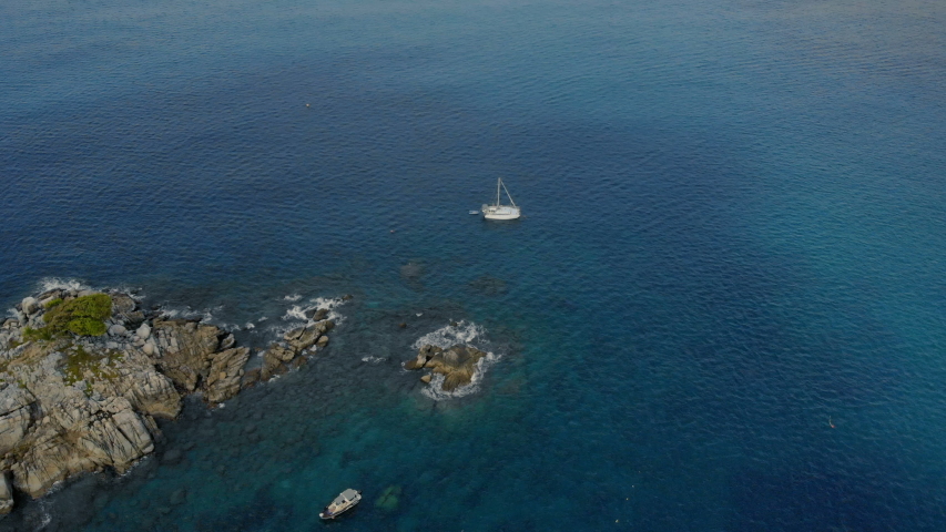 4k small isolated island in the middle of the ocean, above drone shot
sunshine clear water, bird eye view