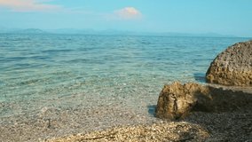 Beautiful view of the Ionian sea in Corfu, Greece, stones in the rocky beach. ProRes 10  bit. 4K UHD video.