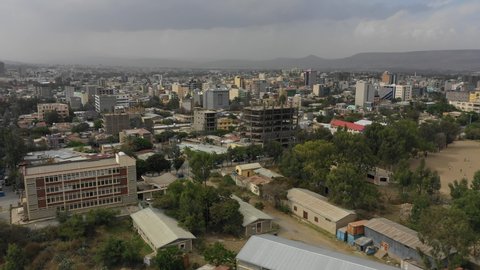 MEKELE, ETHIOPIA – MARCH 2019: Ascending drone flight towards construction site and skyline of Mek' ele with residential and commercial neighborhoods, urbanization and development in Ethiopia Africa