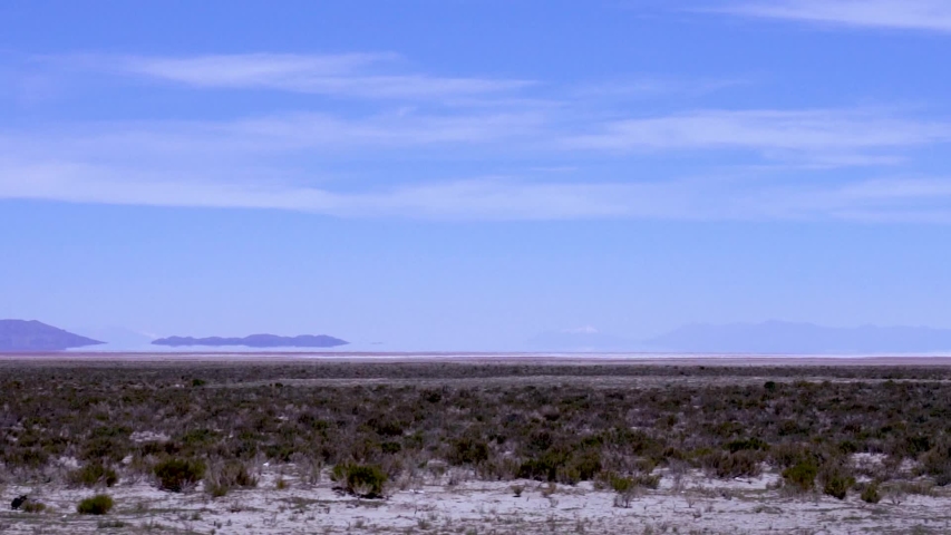 Desert with Fata morgana, mirage reflections and Mountains in Horizon as seen from train, near Salar de Uyuni salt flats and Atacama Desert, Bolivia, Chile Latin America, slow motion