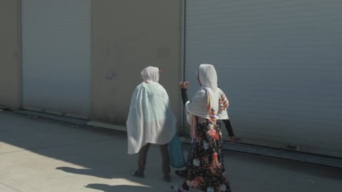 Somali ladies walking away from camera