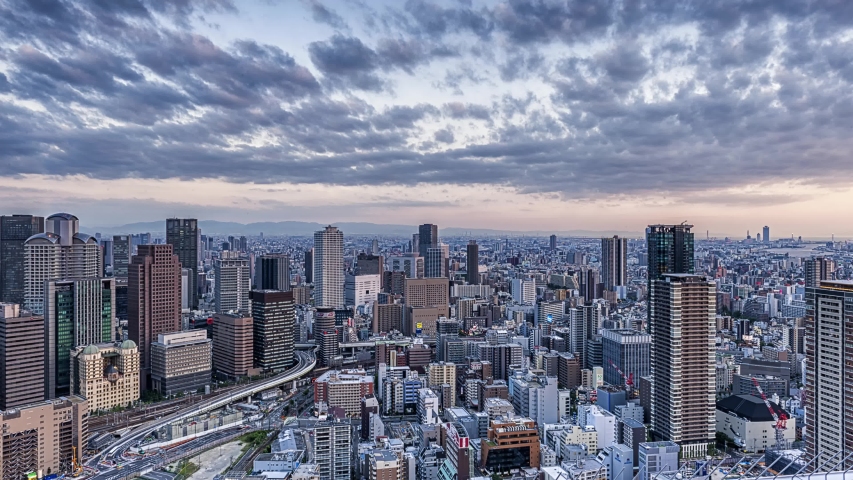 Aerial Osaka Cityscape at Night shot from Umeda Sky Building with Road Traffic. The most famous observation deck of Osaka.