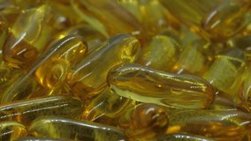 Fish capsules rotating in a detailed macro shot. Ideal to use in videos related to healthcare, alternative medicine, natural medicine, supplements, dietary, nutrition, weight loss, vitamins etc.