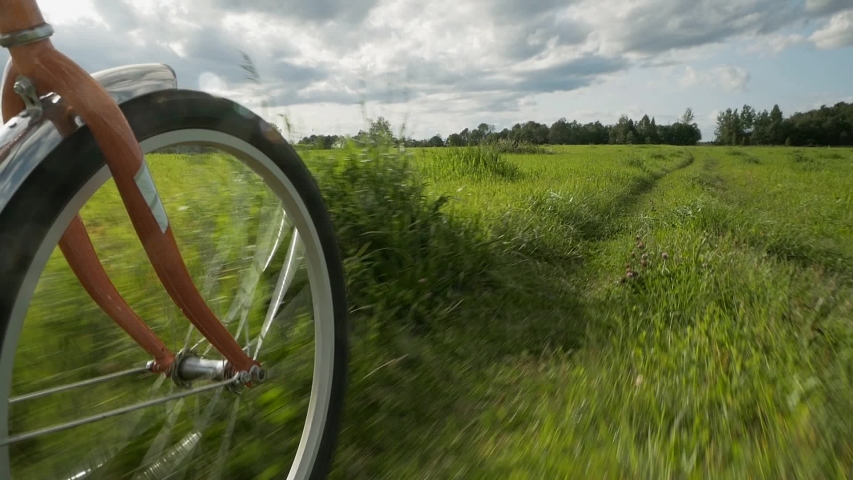 cyclist rides on a path in the field.