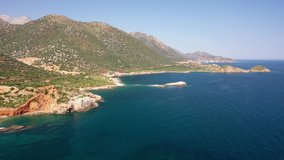 Aerial video view from drone flying along coast and sea near Kalo Horafi or Vossako beach on Crete, Greece, Rethymno prefecture.