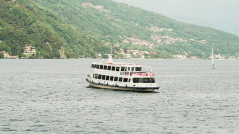 Menaggio, Italy - August 17, 2019: Public transportation boat in perfect parallax on Lake Como.