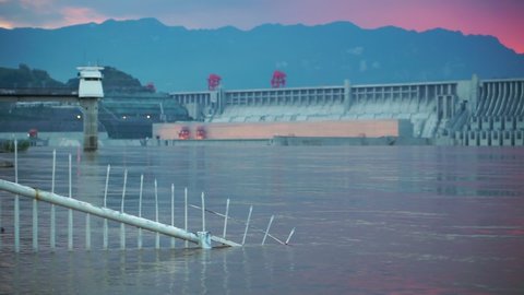Three Gorges Dam at Sunset from the front, a pan along the water front structure