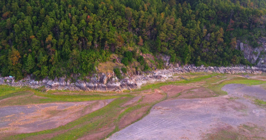 aerial shots at low altitude revealing the coast and coastal edge of Lake Caburgua
