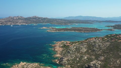 View from above, stunning aerial view of the Maddalena Archipelago National Park with some islands surrounded by a beautiful turquoise clear sea, Caprera island in the distance. Sardinia, Italy.