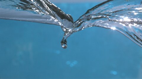 
Pure Water Waves Splashing on Blue Background in Slow Motion at 1500 fps