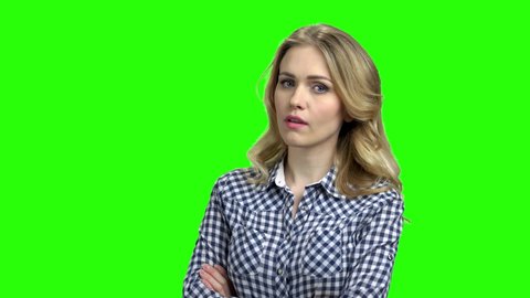 Doubtful pensive woman on green screen. Woman with skeptical and dissatisfied look expressing mistrust. Distrust, skepticism and doubt concept.