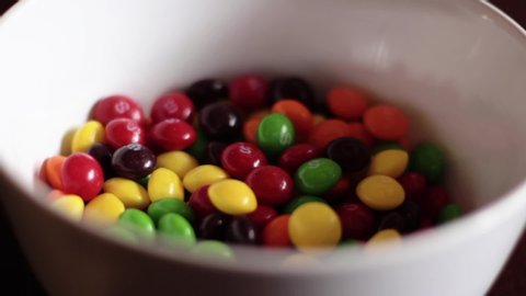 Kelowna, Canada - 06 05 2019: Pouring Skittles Candy Into Bowl