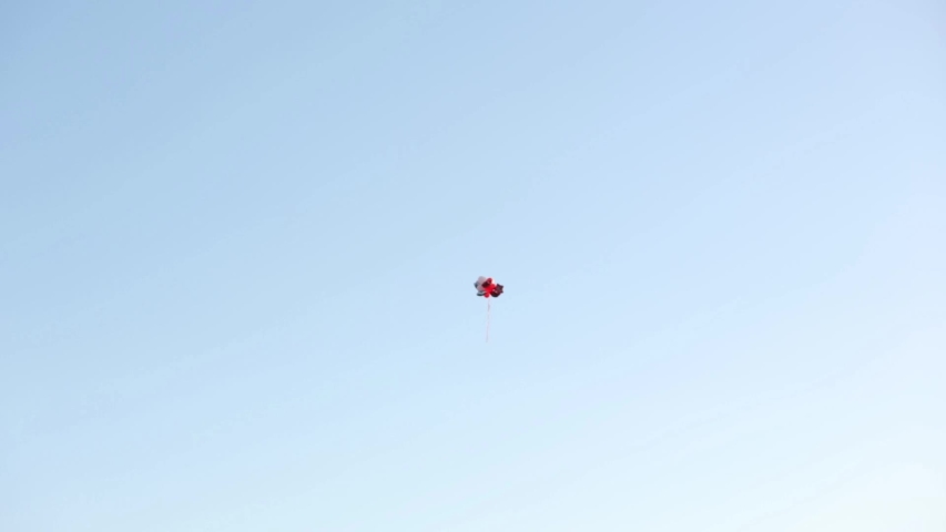 A group of balloons floating away in the sky.