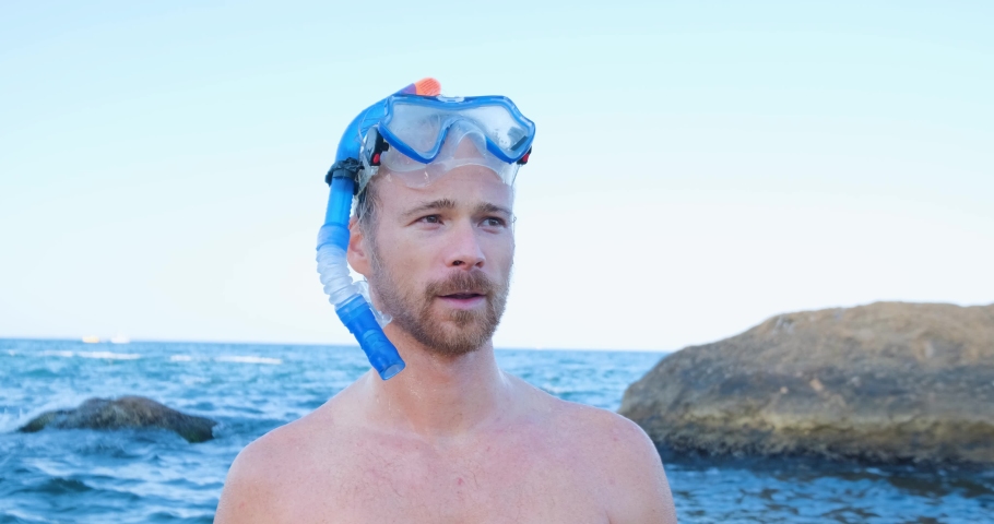 Young male swimmer  with snorkling glasses dive in the summer sea 