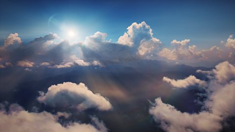 Flying through heavenly beautiful sunny cloudscape. Amazing timelapse of golden fluffy clouds moving softly on the sky and the sun shining through the clouds with beautiful rays and lens flare.