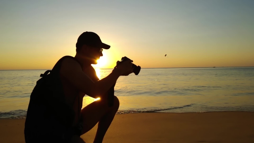 male Photographing Sunset Over the Sea.