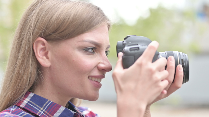 Beautiful Woman Photographer Smiling while Holding Camera | Shutterstock HD Video #1035820412