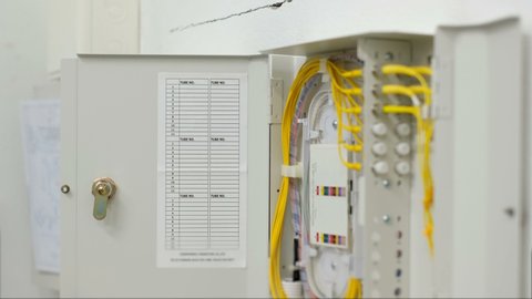 fiber optic cable connected to enclosure box in a technology data center room for high speed communication.