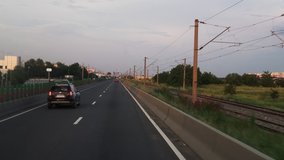 FPV: Driving along the highway. View of the road from the car window. Cars go to a meeting.