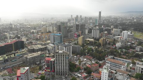 ADDIS ABABA, ETHIOPIA – MARCH 2019: Flying backwards from Addis Ababa skyline, fast changing and developing capital city of Ethiopia