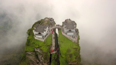 Aerial view of Mount Fanjing (Fanjingshan) in Guizhou Province, China. Video features temples on top of the mountain with a mystical effect added by the clouds.
