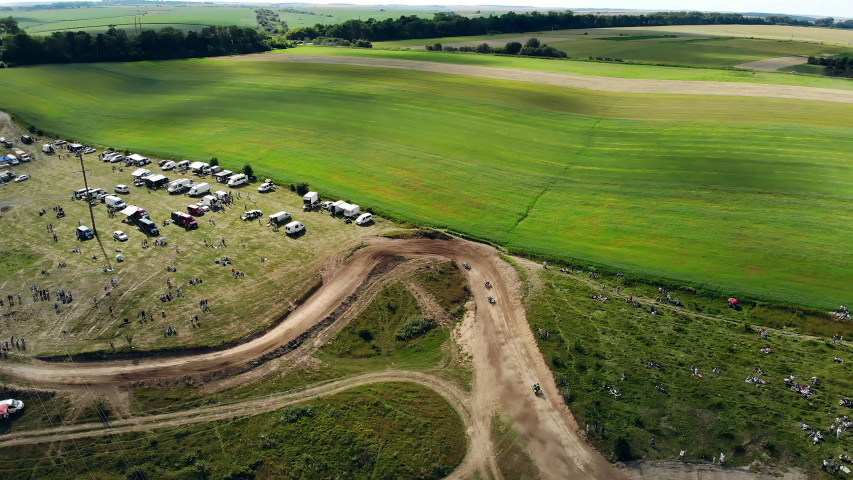 Aerial view of the motocross track. Motorcycle race on green field background. Steep turns on the motocross track