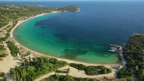 Aerial drone video of famous turquoise organised beach of Paliouri in Kassandra Peninsula, Halkidiki, North Greece