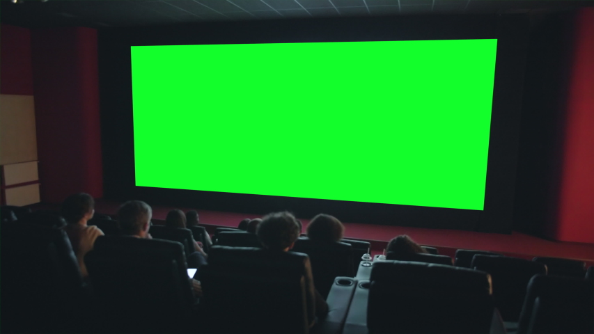 Viewers people are enjoying interesting movie on big green screen copyspace in dark cinema looking with attention. Template, entertainment and films concept. | Shutterstock HD Video #1035862067