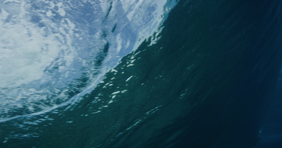 Underwater shot of the silhouette of a surfer getting barreled, amazing surf cinematography Royalty-Free Stock Footage #1035869156