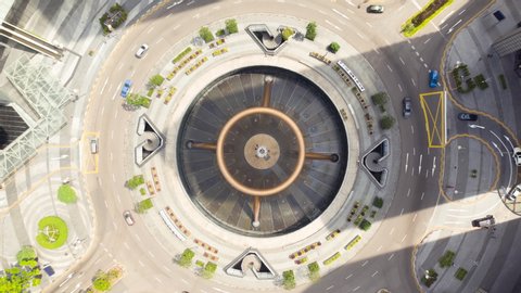Hyperlapse aerial view flying vertical spot of Fountain of Wealth near suntec city mall at daytime in Singapore cityscape.