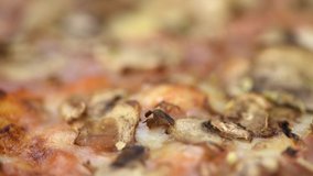 Portion of fresh made Mushroom Pizza in detailed 4K (close-up footage; seamless loopable)