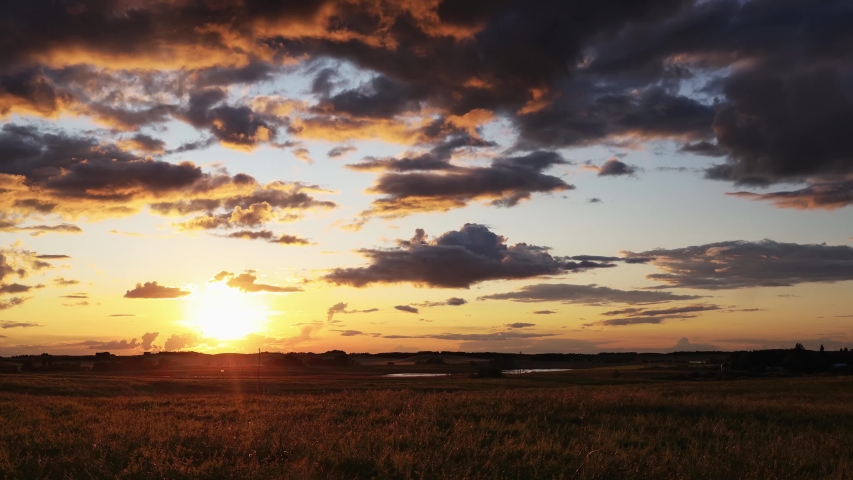 Sunset timelapse over the farmer's pasture in Alberta's Prairies, Canada. Blue sky with moving clouds. Canadian Prairies | Shutterstock HD Video #1035889682