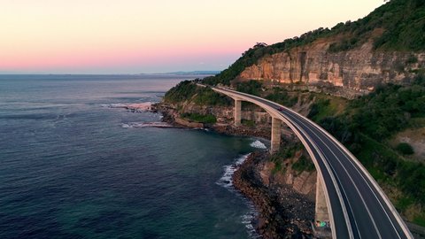 Aerial Drone Video of Cars Driving over Sea Cliff Bridge, Illawarra, Wollongong, NSW, Australia at Sunrise