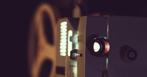 closeup of retro 8mm film projector. dolly shot