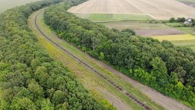 drone flying over rail tracks and field