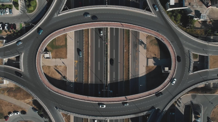 Aerial footage from drone, top down view, cars running on the freeway intersection. | Shutterstock HD Video #1035902093