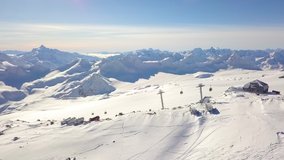 Snow-capped mountains, a ski slope with a lift. Elbrus, aerial video shooting