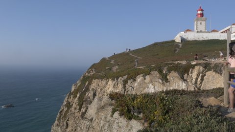 Tourists At Cabo da Roca Famous Landmark In Portugal. SINTRA, PORTUGAL - 24 AUGUST 2019; Cabo da Roca is a cape which forms the westernmost point of the Sintra Mountain Range, of mainland Portugal