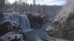 Flying over a winter waterfall in Rastoke, Croatia