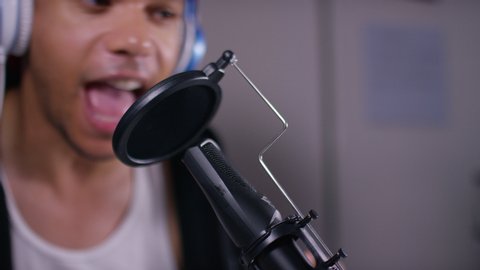 Close up of podcast presenter or DJ talking on the microphone, with space for text