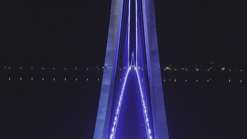 drone ascending in front of LED lighted bridge in Osijek / Croatia